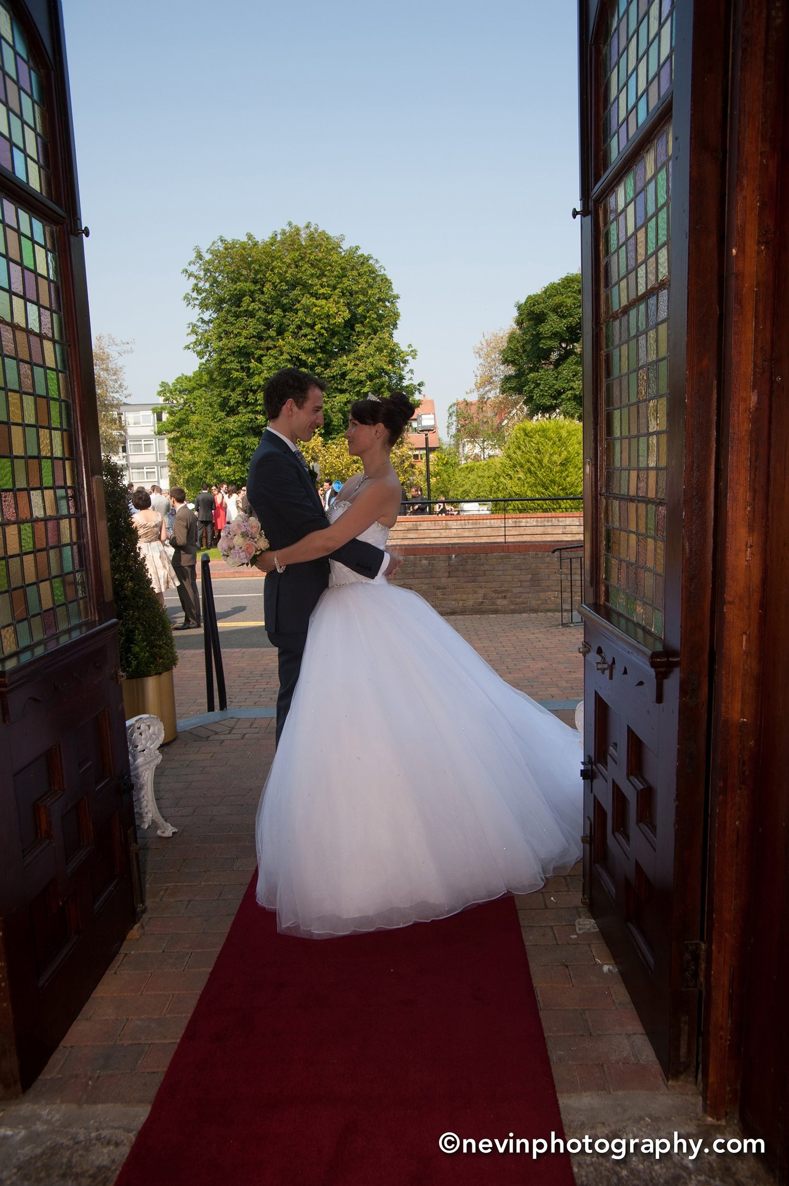 Bride and groom embrace at Thomas Prior Hall